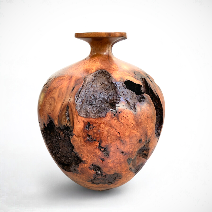 Handcrafted cherry burl vase with intricate grain patterns and warm tones