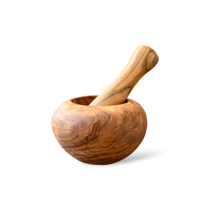 A palm-sized olive wood mortar and pestle handmade in Tunisia. Both mortar and pestle are made from solid  solid wood.