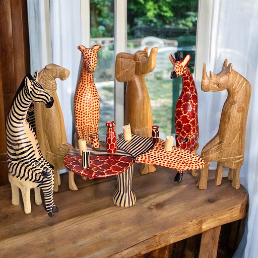 Hand-carved mahogany African animal sculptures seated around Africa-shaped table with wood cups and drinks flask. Made in Kenya.