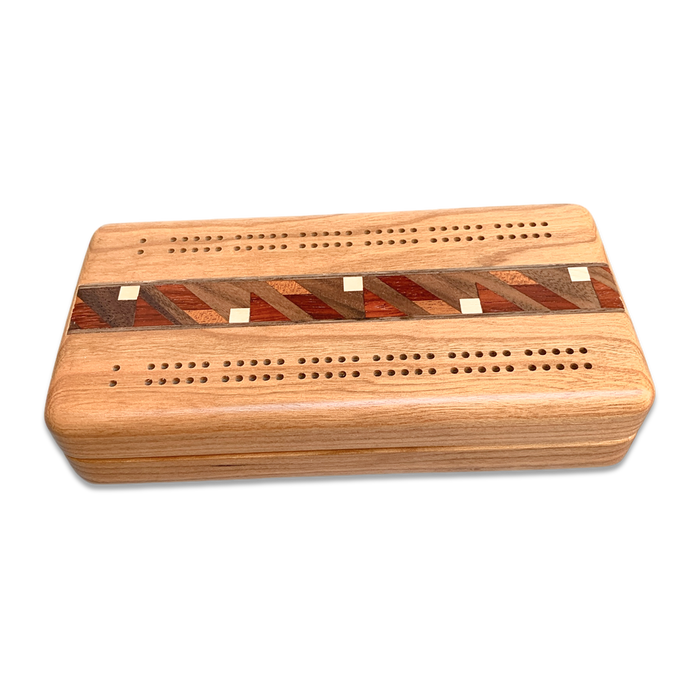 Travel cribbage board with multi-wood inlay.  Playing cards and pegs inside.